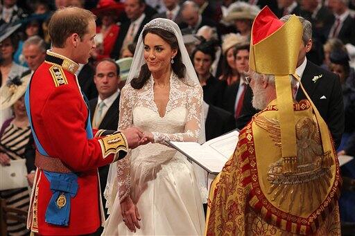 Britain's Prince William and Kate Middleton exchange rings in front of the Archbishop.