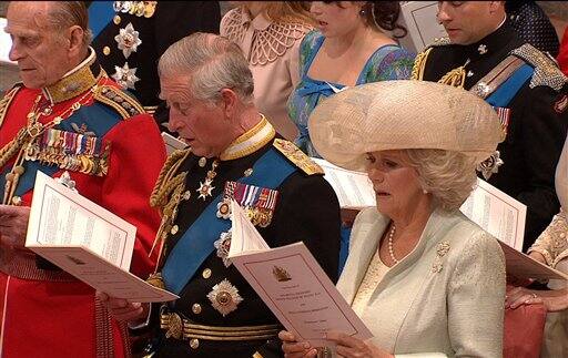 Britain's Prince Philip, Britain's Prince Charles, and Camilla, Duchess of Cornwall, sing during the ceremony at Westminster Abbey.