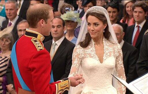 Britain's Prince William, left, takes the hand of his bride, Kate Middleton, as they stand at the altar at Westminster Abbey for the Royal Wedding.