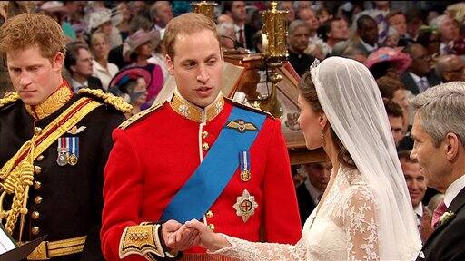 Britain's Prince William, center, takes the hand of his bride, Kate Middleton, as they stand at the altar at Westminster Abbey for the Royal Wedding in London.