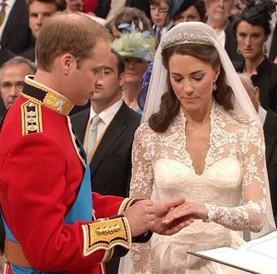 Britain's Prince William, left, places the ring on the finger of his bride, Kate Middleton, as they stand at the altar at Westminster Abbey.