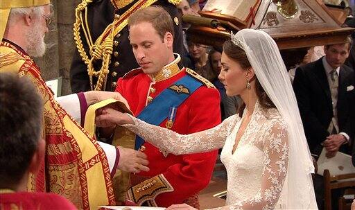 Britain's Prince William, left, stands with his wife, Kate, the Dutchess of Cambridge, as they stand at the altar at Westminster Abbey.