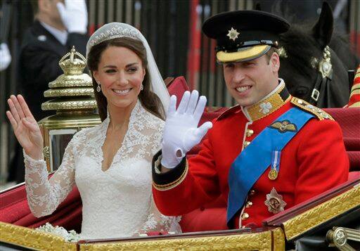 Britain's Prince William and his wife Kate, Duchess of Cambridge, left, wave as they leave Westminster Abbey.