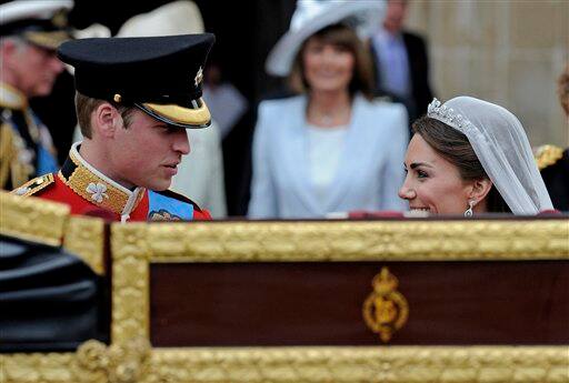 Britain's Prince William and his wife Kate, Duchess of Cambridge wait to get into a landau outside of Westminster Abbey.