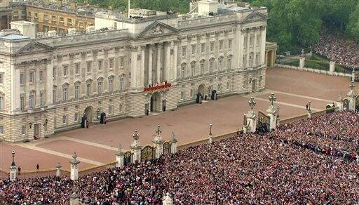 The crowd stands in front of Buckingham Palace, waiting for a kiss between Britain's Prince William and his wife, Kate, the Dutchess of Cambridge, druring the Royal Wedding.