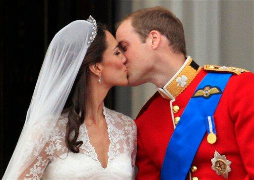 Britain's Prince William kisses his wife Kate, Duchess of Cambridge, on the balcony of Buckingham Palace.