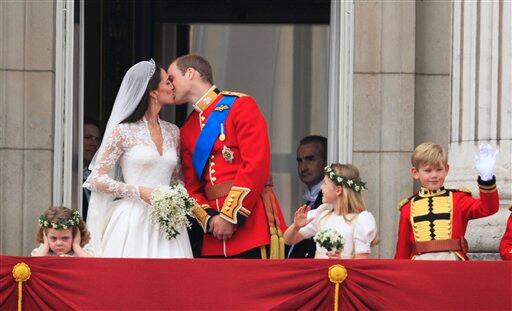 Britain's Prince William kisses his wife Kate, Duchess of Cambridge on from the balcony of Buckingham Palace.