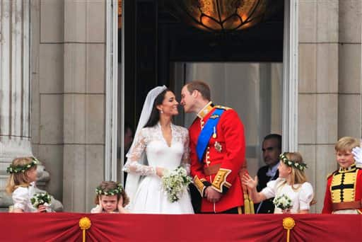 Britain's Prince William kisses his wife Kate, Duchess of Cambridge on from the balcony of Buckingham Palace.