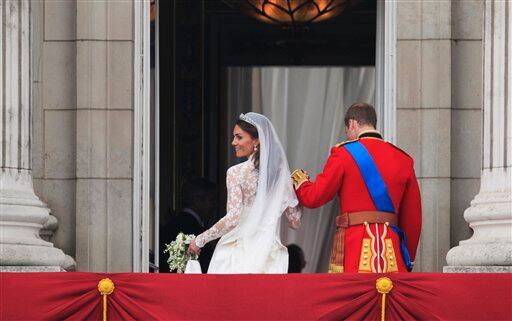 Britain's Prince William and his wife Kate, Duchess of Cambridge go back inside from the balcony of Buckingham Palace.