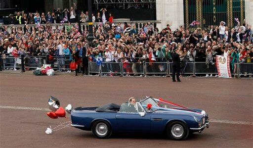 Britain's Prince William and his wife Kate, Duchess of Cambridge drive away from Buckingham Palace in a convertible after the Royal Wedding in London.