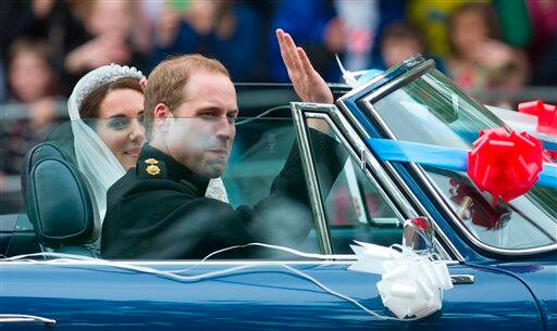 Britain's Prince William drives his wife Kate, Duchess of Cambridge, away from Buckingham Palace in a vintage Aston Martin Volante convertible after their wedding at London's Westminster Abbey.