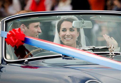 Britain's Prince William drives his wife Kate, Duchess of Cambridge, away from Buckingham Palace in a vintage Aston Martin Volante convertible after their wedding at London's Westminster Abbey.