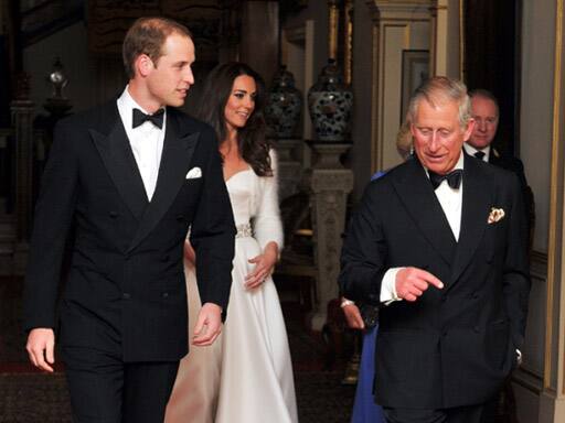 Britain's Prince Charles, right, walks with Prince William followed by his wife Kate Middleton and Camilla, unseen, the Duchess of Cornwall, as they make their way to Buckingham Palace for an evening reception in London.