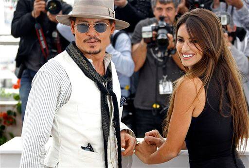 Actors Johnny Depp and Penelope Cruz pose during a photo call for Pirates of the Caribbean: On Stranger Tides.