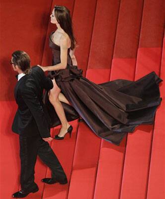 Actors Brad Pitt, foreground, and Angelina Jolie leave following the screening of The Tree of Life at the 64th international film festival, in Cannes.