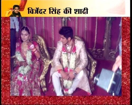 Vijender looks dapper in his ornamented sherwani and Archana looks resplendent in her traditional Indian bridal attire.