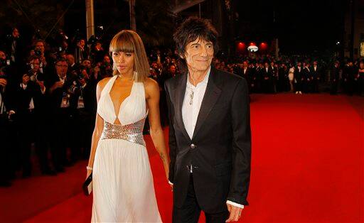 Model Ana Araujo, left, and musician Ronnie Wood arrive for the screening of Melancholia at the 64th international film festival, in Cannes.