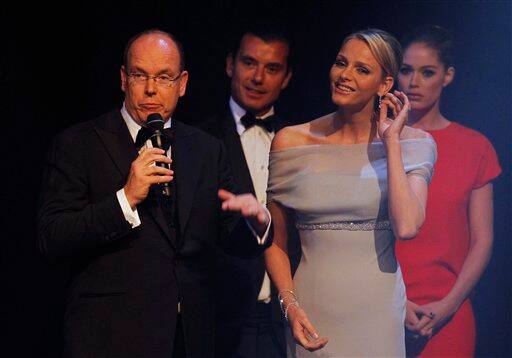 Prince Albert of Monaco, left, and his fiancee Charlene Wittstock are seen on stage during the amfAR Cinema Against AIDS benefit at the Hotel du Cap-Eden-Roc, during the 64th Cannes international film festival, in Cap d'Antibes, southern France.