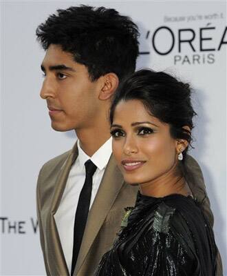 Actor Dev Patel, left, and Freida Pinto arrive for the amfAR Cinema Against AIDS benefit at the Hotel du Cap-Eden-Roc, during the 64th Cannes international film festival, in Cap d'Antibes, southern France.