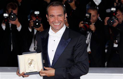 Actor Jean Dujardin holds the award for Best Actor for the film The Artist during the awards photo call at the 64th international film festival, in Cannes.