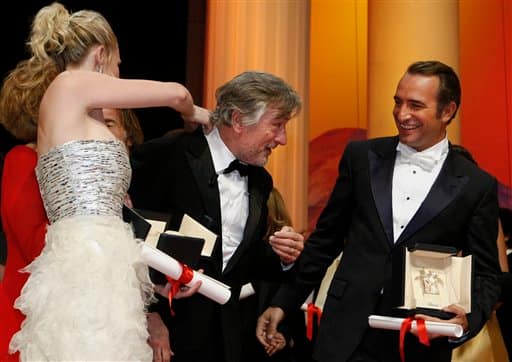 President of the jury Robert De Niro, center, talks with Best Actress award recipient Kirsten Dunst, left, and Best Actor award recipient Jean Dujardin, right, during the awards ceremony at the 64th international film festival, in Cannes.