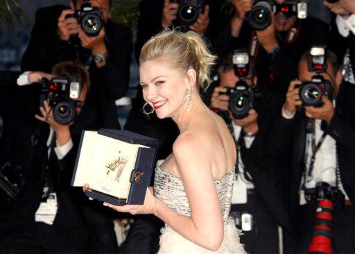 Actress Kirsten Dunst poses with the Best Actress award for the film Melancholia during the awards photo call at the 64th international film festival, in Cannes.