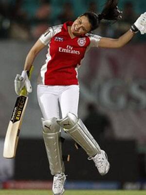 Preity Zinta celebrates after hitting a four during an exhibition match.