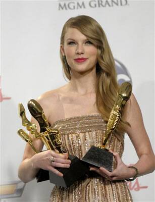 Singer Taylor Swift poses with her awards in the press room at the 2011 Billboard Music Awards in Las Vegas.