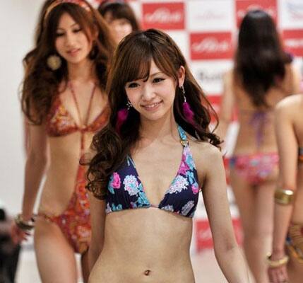 A model displays Japanese apparel giant Sanai's latest swimsuits collection at the company's remodeled flagship shop in Tokyo.