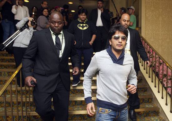 Bollywood actor Ritesh Deshmukh walks out of a hotel followed by security and fans in Toronto. The International Indian Film Academy (IIFA) Awards will be held in Toronto on June 25.