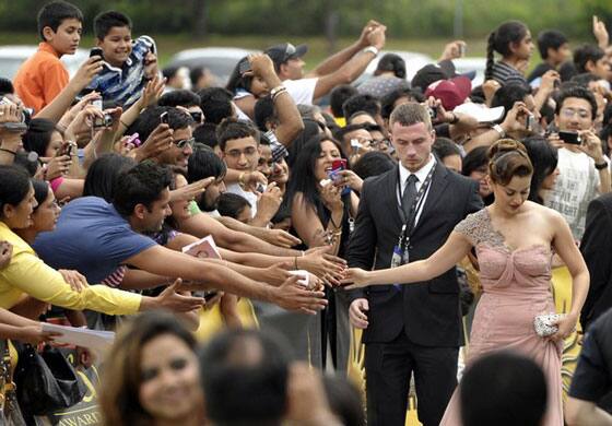 Bollywood actress Kangna Ranaut (R) greets fans at the world premiere of the film 