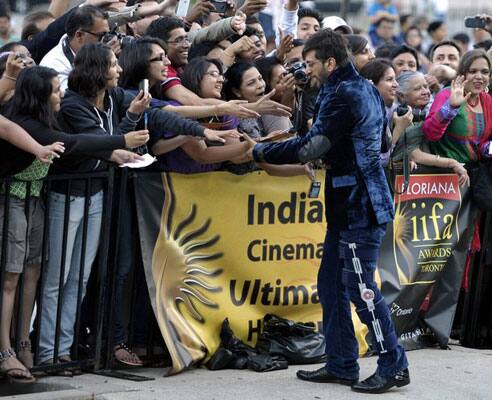 Bollywood actor Jaaved Jaaferi (R) greets fans at the world premiere of the film 