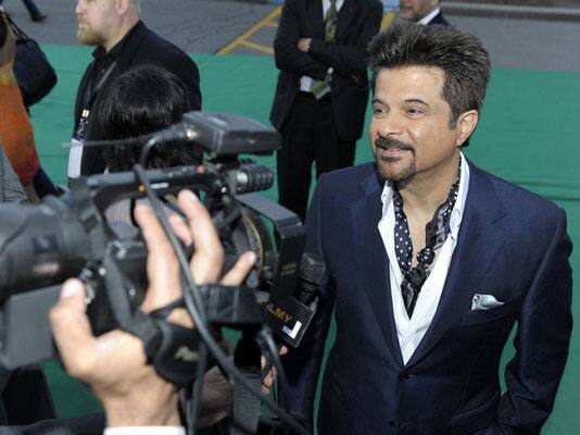 Bollywood actor and producer Anil Kapoor is interviewed on the green carpet at the premiere of the film 