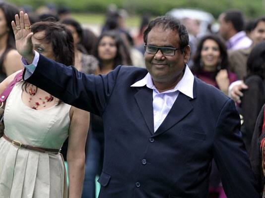 Bollywood actor Satish Kaushik waves as he arrives for the world premiere of the film 