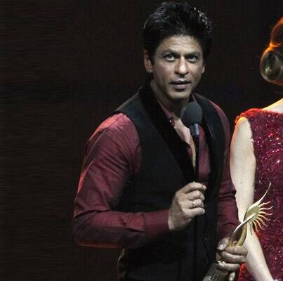 Shah Rukh Khan accepts his award best male actor during the International Indian Film Academy (IIFA) awards.