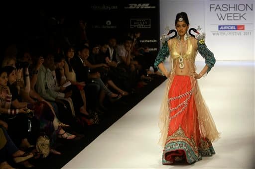 An Indian model displays designer Parvesh Jai creations during the Lakme Fashion Week .