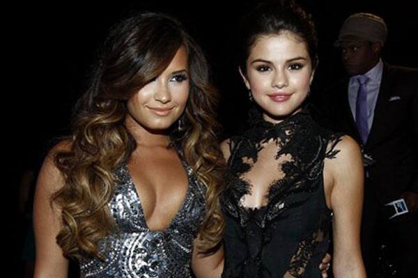 Demi Lovato, left, and Selena Gomez arrive at the MTV Video Music Awards in Los Angeles. 