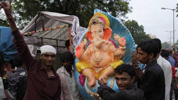 Devotees prepare to transport an idol of Hindu god Ganesh ahead of Ganesh Chaturti festival in Ahmadabad.