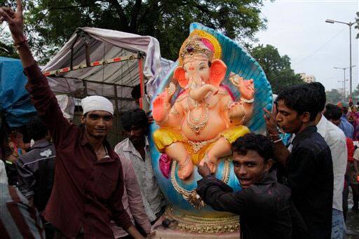 Indian devotees prepare to transport an idol of elephant headed Hindu god Ganesh ahead of Ganesh Chaturti festival in Ahmadabad.