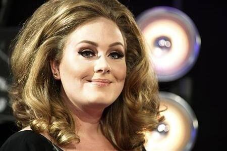 Singer Adele poses on arrival at the 2011 MTV Video Music Awards in Los Angeles.