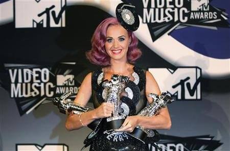 Katy Perry poses with her three awards, Video of the Year for ‘Firework’, Best Collaboration, and Best Special Effects which she won at the 2011 MTV Video Music Awards in Los Angeles.