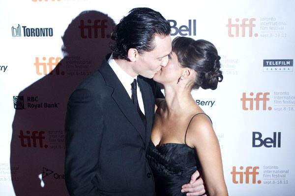 Tom Hiddleston, left, kisses his wife Susannah Fielding as they arrive for the gala screening of the film 