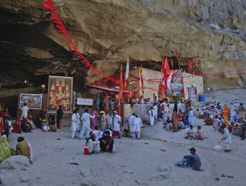 Pilgrims take rest outside the cave temple. 