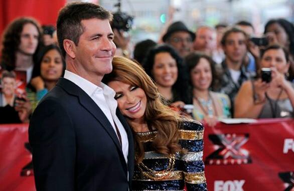 Simon Cowell and Paula Abdul, judges on 'The X Factor,' pose together at a world premiere screening event for the new television series.