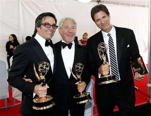 Director Michael Alan Spiller, writer Jeffrey Richman, and writer Steve Levitan pose backstage with their awards for outstanding directing for a comedy series and outstanding writing for a comedy series at the 63rd Primetime Emmy Awards.