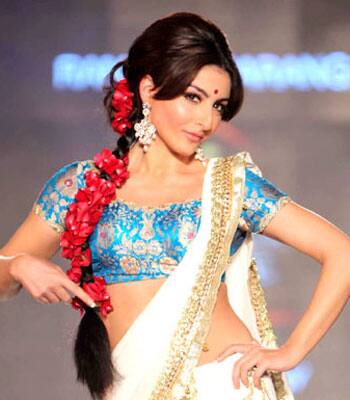 Soha Ali Khan goes traditional wearing a saree at a fashion event.