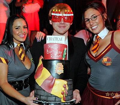 Rupert Grint celebrating his 23rd b'day in Las Vegas with giant cake, gaggles of girls and silly shades.