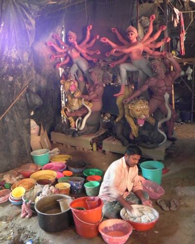 A worker mixes paint at workshop in C R Park in New Delhi.