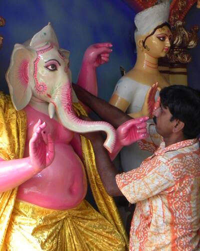 Last minute details are added on Ganesh idol by an artist ahead of Durga Puja celebrations in New Delhi.