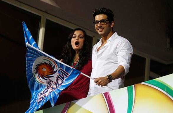 Zayed Khan and Diya Mirza cheer for Mumbai Indians team before the start of the Champions League Twenty20 cricket match between Mumbai Indians and Trinidad and Tobago in Bangalore.